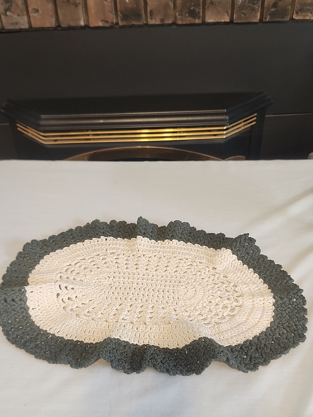 Homemade Oval Dollie With A Cream Center and a Dark Gray Ruffled Border Vintage